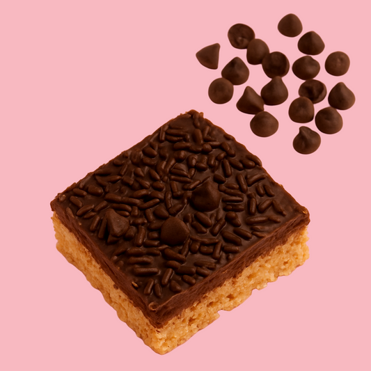 Chocolate-covered rice krispie treat with chocolate chips on a pink background